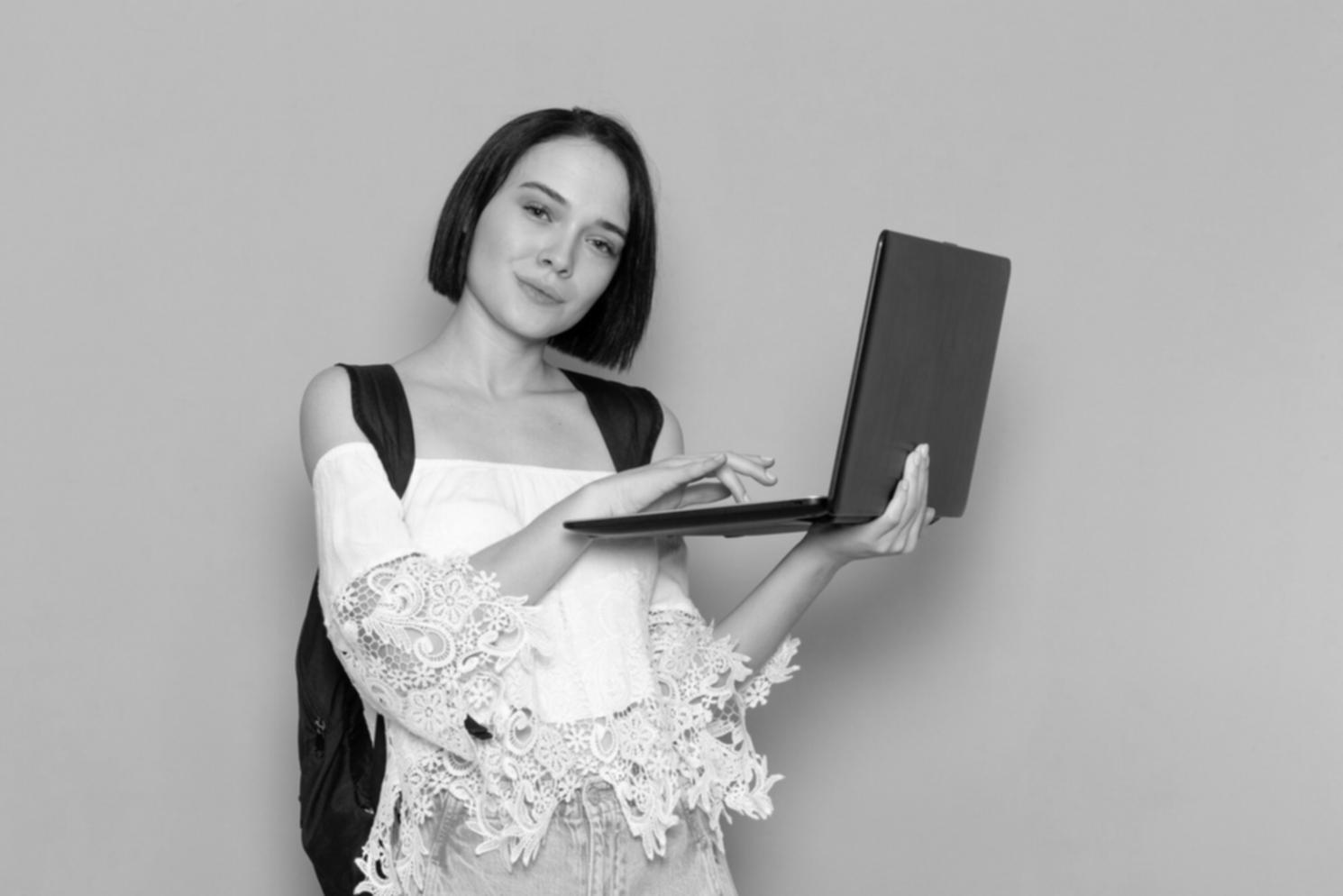 Students collaborating on JavaScript game project with laptops and shared screen